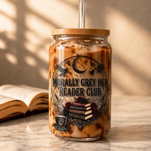 Glass tumbler with "Morally Grey Men Reader Club" text and book and sword imagery.