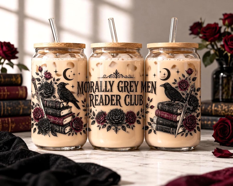 May include: Three glass tumblers with wooden lids and glass straws, filled with a creamy beverage. Each tumbler features a design with a raven, books, a sword, roses, and the text "MORALLY GREY MEN READER CLUB".