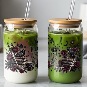 Two glass cups with straws, one with layered green tea and milk, the other with green tea, both with dark floral and book designs.