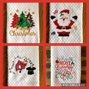 May include: Four white kitchen towels with embroidered Christmas designs. The first towel has a red and green Christmas tree design with the text "Merry Christmas". The second towel has a red and white Santa Claus design with the text "Ho Ho Ho". The third towel has a snowman design with a red and white scarf and a black top hat. The fourth towel has a red and green Christmas ornament design with the text "It's the most wonderful time of the year".
