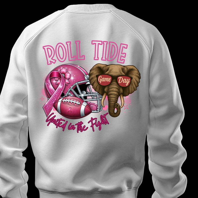 May include: White sweatshirt featuring a pink football helmet, football, and elephant graphic. The text "ROLL TIDE" and "United in the Fight" are displayed in pink. The elephant wears sunglasses that say "Game Day".
