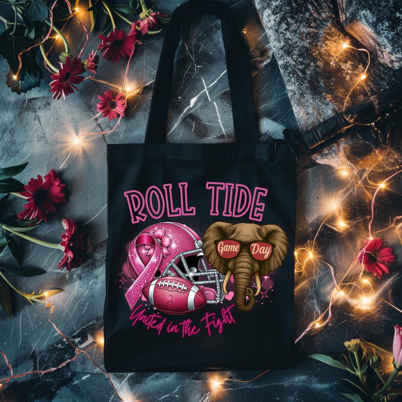 May include: Black tote bag with the text "ROLL TIDE" in pink. The bag features a pink football helmet, a football, and an elephant wearing sunglasses. The phrase "United in the Fight" is also on the bag.
