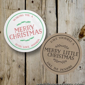 May include: Two round Christmas gift tags. The first tag is white with green and red text that says "Wishing you a Merry Christmas with love, Amanda". The second tag is brown with black text that says "Have yourself a Merry Little Christmas Love the Jacksons".