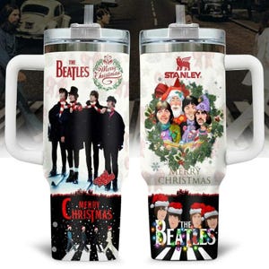 May include: A white insulated tumbler featuring The Beatles. One side shows the band on Abbey Road with "Merry Christmas" text. The other side has a Santa Claus image with the band members and "Merry Christmas" text.