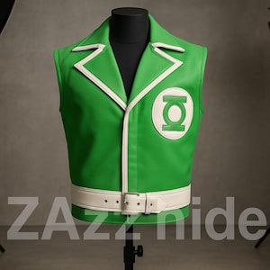 May include: Green vest with white trim and a white belt. The vest features a Green Lantern logo on the chest. The vest is displayed on a black mannequin. The text "ZAzzide" is at the bottom of the image.