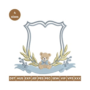 May include: An embroidered design featuring a teddy bear with a blue bow tie, set within a light blue and gold decorative frame. The design includes a banner and olive branches. The text "4 sizes" is in a brown circle.