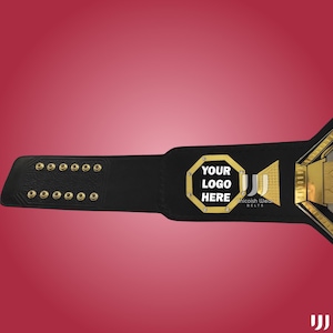 May include: A black championship belt with gold accents and a red background. The belt features the text "YOUR LOGO HERE" in a gold octagon. The belt also has the text "Unicoish Wear Belts".