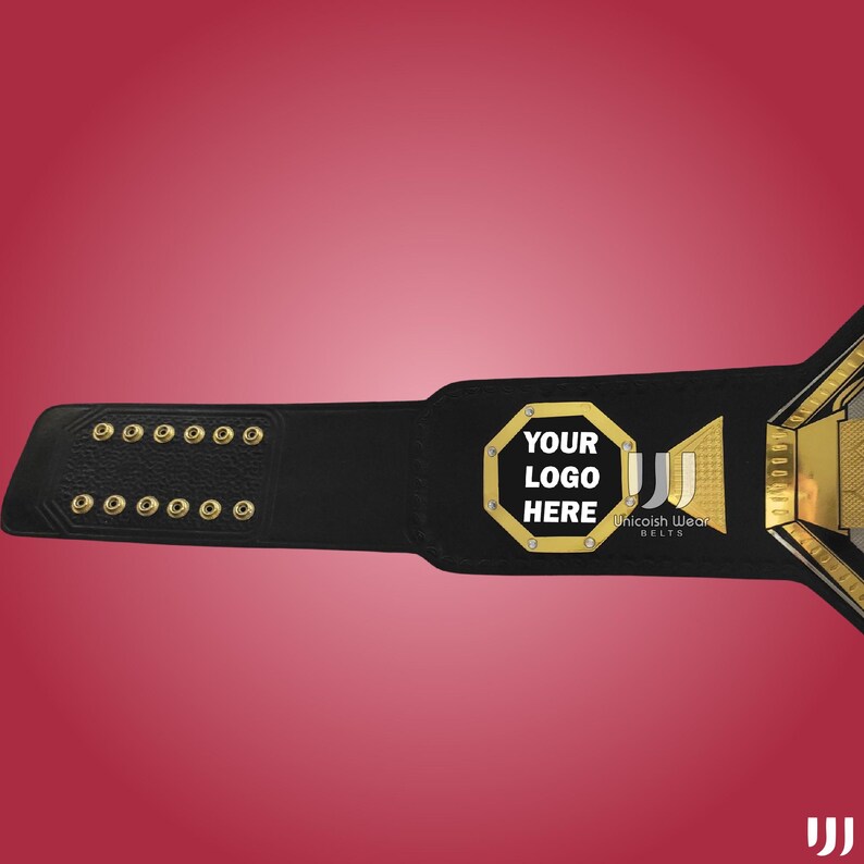 May include: A black championship belt with gold accents and a red background. The belt features the text "YOUR LOGO HERE" in a gold octagon. The belt also has the text "Unicoish Wear Belts".