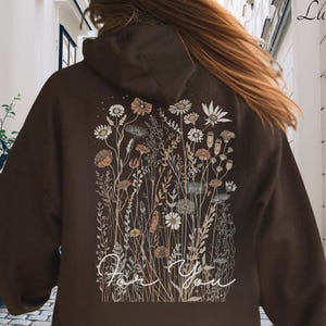 May include: A set of three ceramic mugs with a speckled, matte finish. The mugs are in shades of cream, light grey, and dark grey. Each mug has a simple, minimalist design, ideal for coffee or tea.