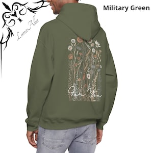 May include: Military green hoodie with a floral design on the back, featuring wildflowers in shades of orange, beige, and white. The words "For You" are written in a cursive font below the flowers. The hoodie has a hood and long sleeves.
