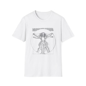 May include: White t-shirt featuring a black and white line drawing of a woman in a dress, arms and legs outstretched, within a circle. The design is reminiscent of Leonardo da Vinci's Vitruvian Man.