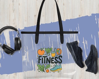 May include: Clear tote bag with black handles and a "FITNESS" graphic featuring an apple, vegetables, a drink, a watch, and a shoe. Black sneakers and headphones are also visible. The bag is on a light blue background.