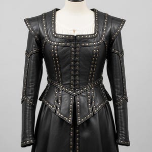 May include: Black leather jacket with a square neckline, studded details, and a braided front closure. The jacket features long sleeves and a fitted waist, creating a structured silhouette. The garment is displayed on a mannequin.