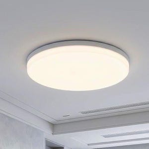 May include: A circular flush mount ceiling light fixture with a white frame and a translucent white diffuser panel that emits a soft, even glow. The light is mounted directly against a smooth, flat white ceiling surface in a room interior.