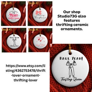 May include: White ceramic Christmas ornaments with gold string, featuring various designs and text like "Merry Thriftmas" and "Haul Yeah!". The ornaments are displayed on a red knitted background with candy canes.