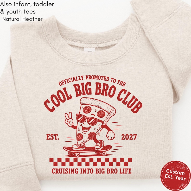 May include: A natural heather crewneck sweatshirt featuring a red graphic of a pizza slice on a skateboard wearing sunglasses and making a peace sign. The text reads OFFICIALLY PROMOTED TO THE COOL BIG BRO CLUB EST. 2027 CRUISING INTO BIG BRO LIFE.