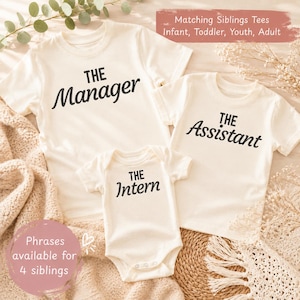 May include: Off-white t-shirts and a onesie with black text. The shirts say "The Manager" and "The Assistant", while the onesie says "The Intern". The image includes text that says "Matching Siblings Tees" and "Phrases available for 4 siblings".