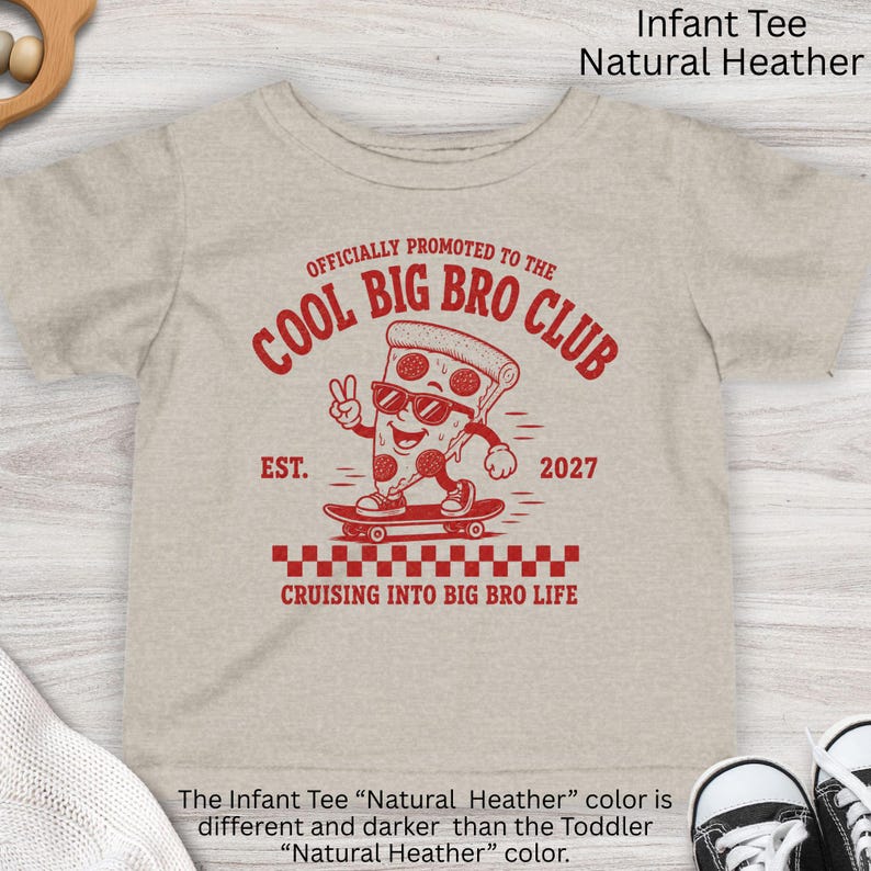 May include: A natural heather infant t-shirt featuring a red graphic of a pizza slice wearing sunglasses on a skateboard. The text reads: OFFICIALLY PROMOTED TO THE COOL BIG BRO CLUB, EST. 2027, and CRUISING INTO BIG BRO LIFE with a checkered pattern.