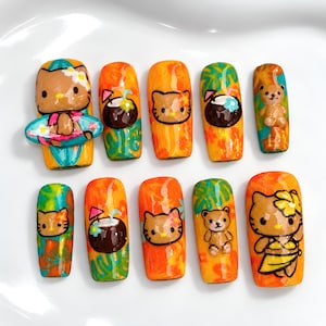 May include: A set of ten press-on nails featuring a tropical theme with orange and green backgrounds. Designs include Hello Kitty characters, a teddy bear, coconuts with straws, and floral patterns. The nails have a glossy finish and vibrant colors.