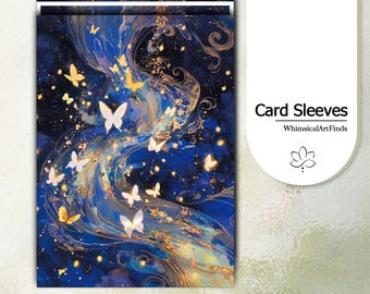 May include: A set of rectangular card sleeves featuring a deep blue background with swirling gold accents and numerous white butterflies. The text Card Sleeves and WhimsicalArtFinds is printed on the right side above a small lotus flower icon.
