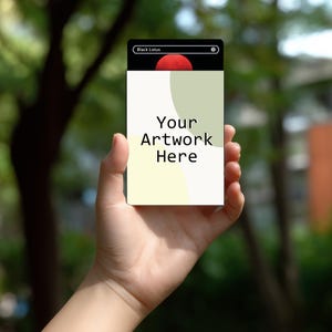 May include: A rectangular card with the text "Your Artwork Here" in a bold, black font. The card has a black top section with the words "Black Lotus" and a red circle design. The background is blurred green.