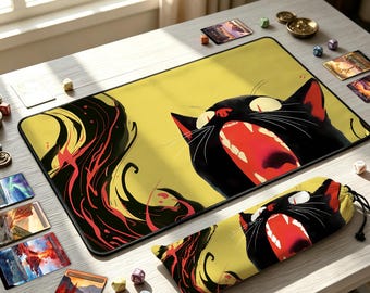 May include: A rectangular playmat and a matching drawstring bag featuring a graphic illustration of a black cat with a wide-open mouth, yellow eyes, and flowing red and black abstract shapes against a pale yellow background.
