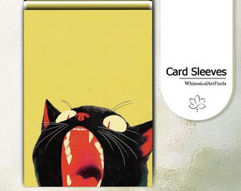 May include: A rectangular card sleeve featuring a yellow background and a graphic illustration of a black cat with its mouth wide open, revealing white teeth and a red interior. The text Card Sleeves and WhimsicalArtFinds appears on the right.
