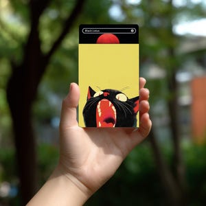 May include: A rectangular trading card featuring a yellow background and a black cat with its mouth wide open, showing red interior details. The top section is black with a white border, containing the text Black Lotus and a zero symbol.