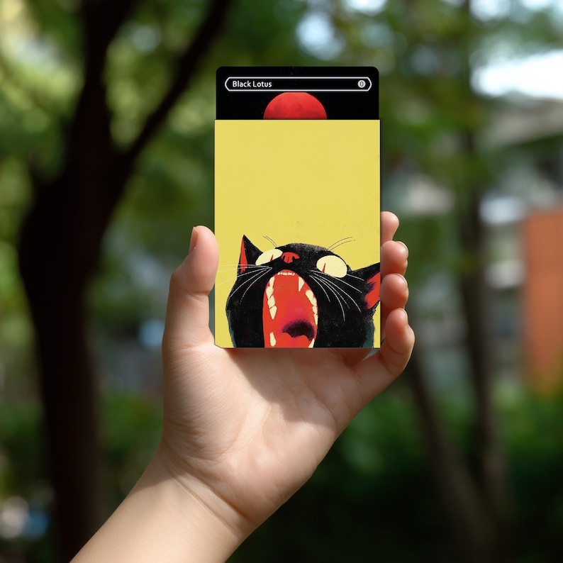 May include: A rectangular trading card featuring a yellow background and a black cat with its mouth wide open, showing red interior details. The top section is black with a white border, containing the text Black Lotus and a zero symbol.