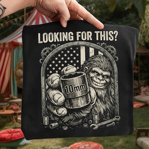 May include: A white ceramic mug with a black handle and the text "But First, Coffee" in a black, bold font. The mug is on a white surface.