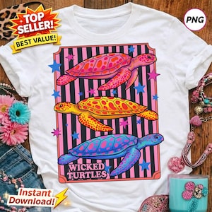 May include: White t-shirt featuring a colorful graphic of three turtles in shades of pink, yellow, and blue. The turtles are set against a pink and black striped background with stars. The text "Wicked Turtles" is at the bottom.