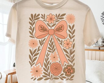 Boho-Blumenmuster mit rosa Schleife (PNG), Preppy-Blumenmuster mit Wildblumen (PNG), Cottagecore-Blumenmuster (PNG), Trendiges Damen-Shirt-Design, Mädchenhaftes Sommer-PNG