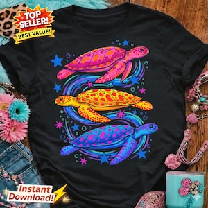 May include: Black t-shirt featuring a vibrant design of three colorful sea turtles. The turtles are in shades of pink, yellow, and blue, surrounded by stars and swirling patterns. The shirt also has text that says "Top Seller! Best Value!" and "Instant Download!"