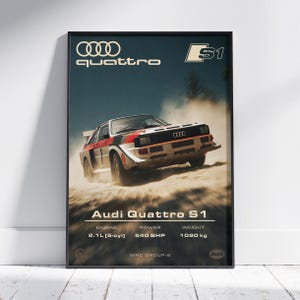 May include: Framed poster featuring an Audi Quattro S1 rally car in action. The car is white, red, and black, kicking up dust. The poster includes the text "quattro" and "S1", along with engine specs: 2.1L (5-cyl), 540 BHP, and 1090 kg.