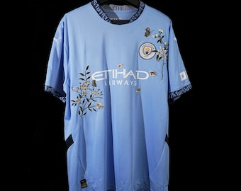 Camiseta del Manchester City bordada a mano: diseño floral de mariposas