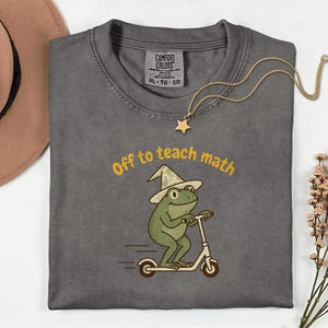 May include: A white ceramic mug with a black handle and the text "But First, Coffee" in a handwritten style. The mug is likely 325-444 ml, ideal for a morning beverage.