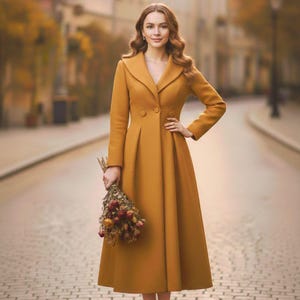 May include: A mustard-yellow, long coat with a wide collar and button closure. The coat has a tailored fit and a flared skirt. The model is holding a bouquet of dried flowers. The coat's length is approximately 55 inches.