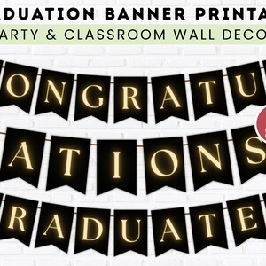 May include: A black banner with gold lettering that reads "CONGRATULATIONS GRADUATES." The banner is strung on a brown string and is designed for party and classroom wall decor. A red circle indicates two sizes are available.