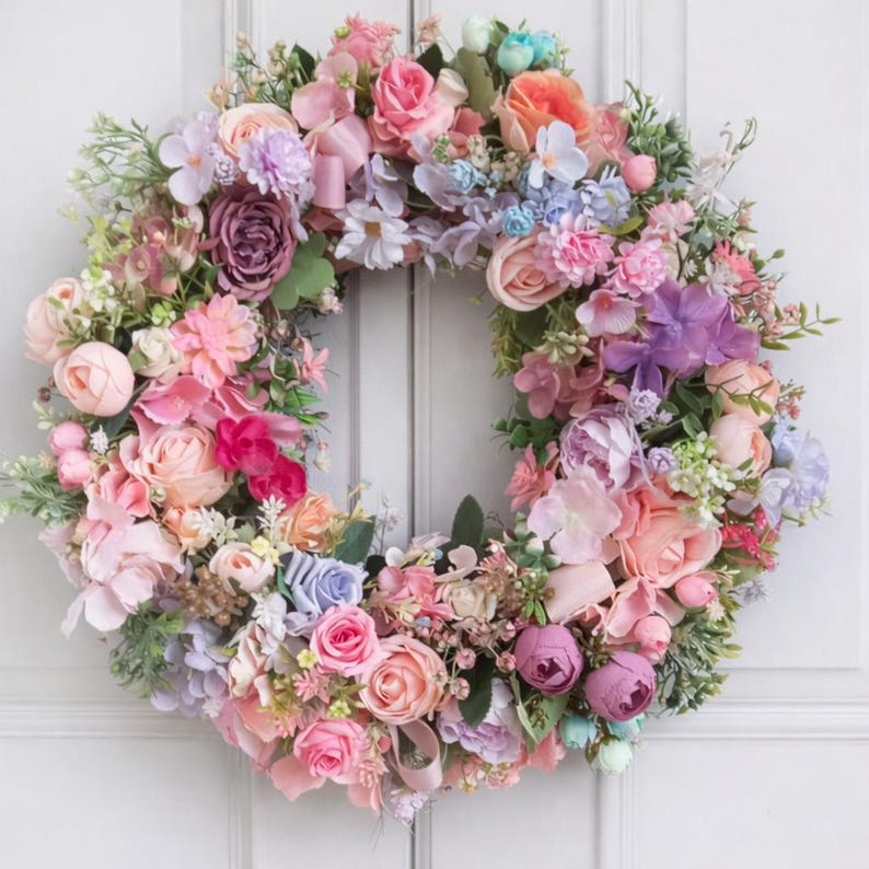 Large spring floral wreath with pastel flowers on white background