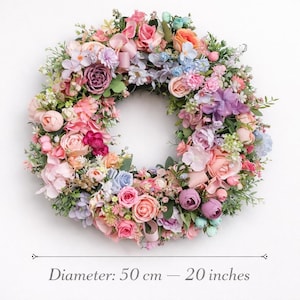 Pastel spring wreath with pink, peach, lavender and blue flowers