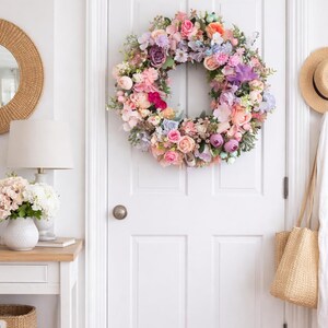 Front door decorated with large spring floral wreath