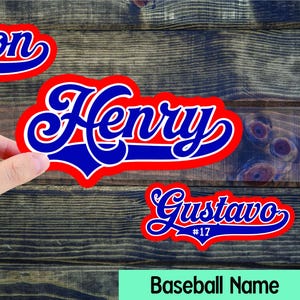 May include: Baseball name stickers in red, white, and blue. The image shows three stickers with the names "Edison", "Henry", and "Gustavo", each with a number. The text "Baseball Name" is at the bottom.