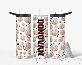 May include: A white tumbler with a black lid and straw, featuring a baseball pattern with stars and dots. The name "DONOVAN" is vertically printed in a bold, red and black font on the center tumbler.