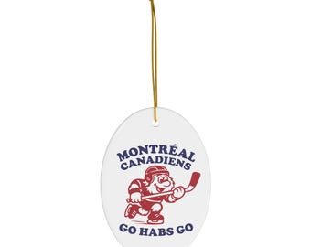 May include: White oval ornament featuring a red and blue hockey player graphic and the text "MONTREAL CANADIENS" and "GO HABS GO". A gold string is attached for hanging.