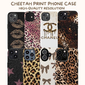 May include: A collection of phone cases with cheetah print designs. The cases feature various patterns, including leopard spots, lips, stars, and bows. Some cases have the word "CHANEL" in gold lettering. The text "CHEETAH PRINT PHONE CASE" is at the top.