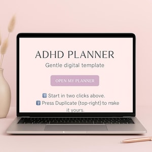 May include: A laptop displays the text "ADHD PLANNER" and "Gentle digital template." A button reads "OPEN MY PLANNER." Instructions below state to start in two clicks and duplicate to make it yours. A pen rests on the table.