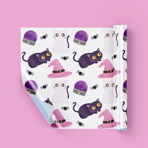 May include: Wrapping paper featuring a repeating pattern on a white background. The design includes illustrations of purple crystal balls, white ghost cats, black cats with large yellow eyes, pink witch hats with black belts, and small black spiders.