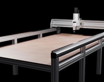 May include: A CNC machine with a light brown work surface and a silver metal frame. The machine has a gantry system with a cutting tool and is designed for precision cutting and fabrication. The background is black.