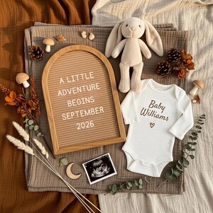 May include: A neutral-toned baby announcement scene. A letter board reads "A LITTLE ADVENTURE BEGINS SEPTEMBER 2026." A white onesie with "Baby Williams" and a heart is next to a plush bunny. An ultrasound photo and decorative elements complete the scene.