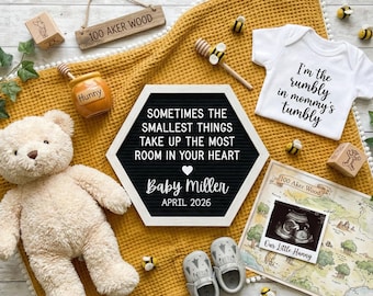 May include: A baby announcement scene with a yellow blanket, teddy bear, and baby shoes. A sign reads "Sometimes the smallest things take up the most room in your heart." A onesie says "I'm the rumbly in mommy's tumbly."
